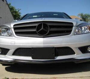 High-quality matte black front lip for C-Class 2008-2011 models, showcasing a sleek design and durable construction.