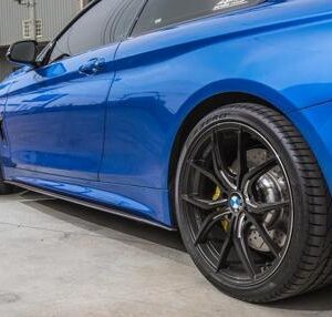 Real carbon fiber side skirt extensions for 2014-2019 BMW F32 and F33 models, finished with UV clear coat.