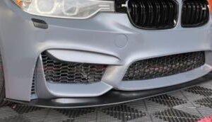 A high-quality image of the F30 M3 CS Front Bumper Conversion, showcasing its primed finish and included accessories.