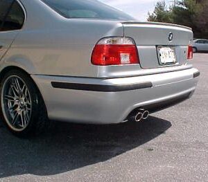 BMW MTech rear bumper for 1997-2003 5 Series sedan, made from durable poly plastic and primed for painting.