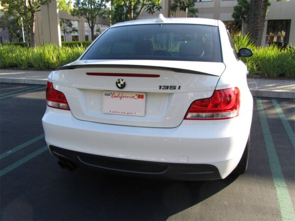 A sleek M Performance Trunk Spoiler designed for the BMW 1 Series (2008-2013) in real carbon fiber.