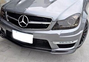 High-quality C63 Carbon Fiber Black Edition Front Lip for 2012-2014 models, showcasing the sleek design and real carbon fiber material.