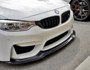 F80 F82 V Style Carbon Front Lip made of real carbon fiber with a clear coat finish.