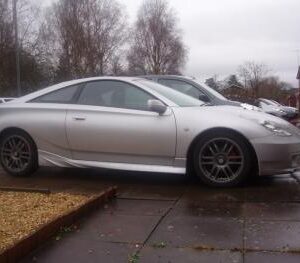 A pair of TRD Style side skirts for 2000-2005 Toyota Celica in white gelcoat finish, showcasing their sleek design.